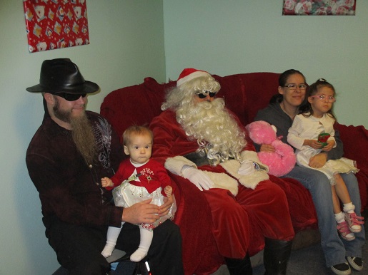 A family sitting with Blind Santa